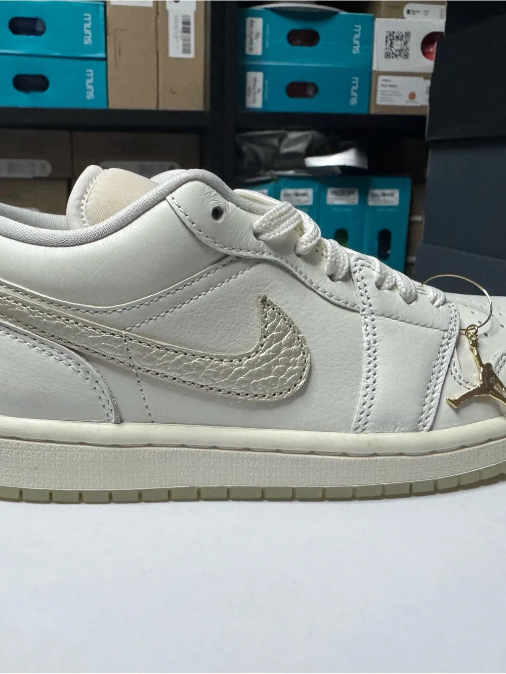 Nike Women's Low-Top Sneaker in Cream with Gold Swoosh